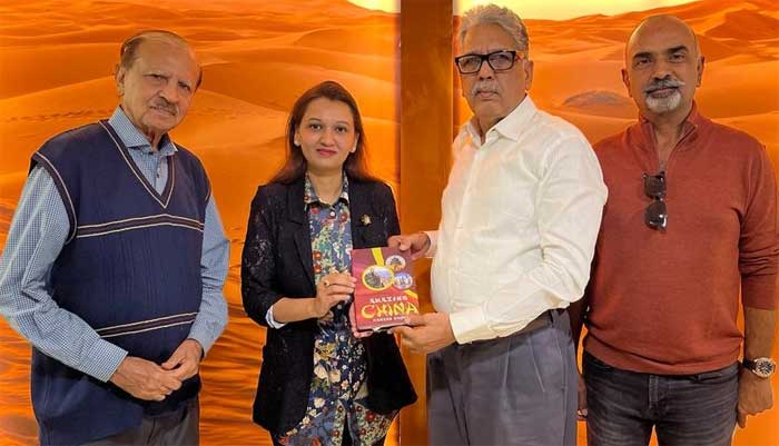 Manzar Naqvi presenting his Book to Sana Sharifuddin Pirzada