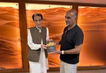 Akif Ashary presents a copy of “The New Development Equation,”