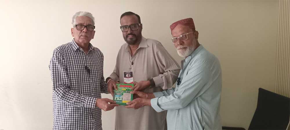 Manzar Naqvi Secretary General Karachi Editors Club presenting a book Manzar Naqvi Secretary General Karachi Editors Club presenting a book