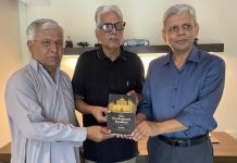 Manzar Naqvi presents a copy of The New Development Equation